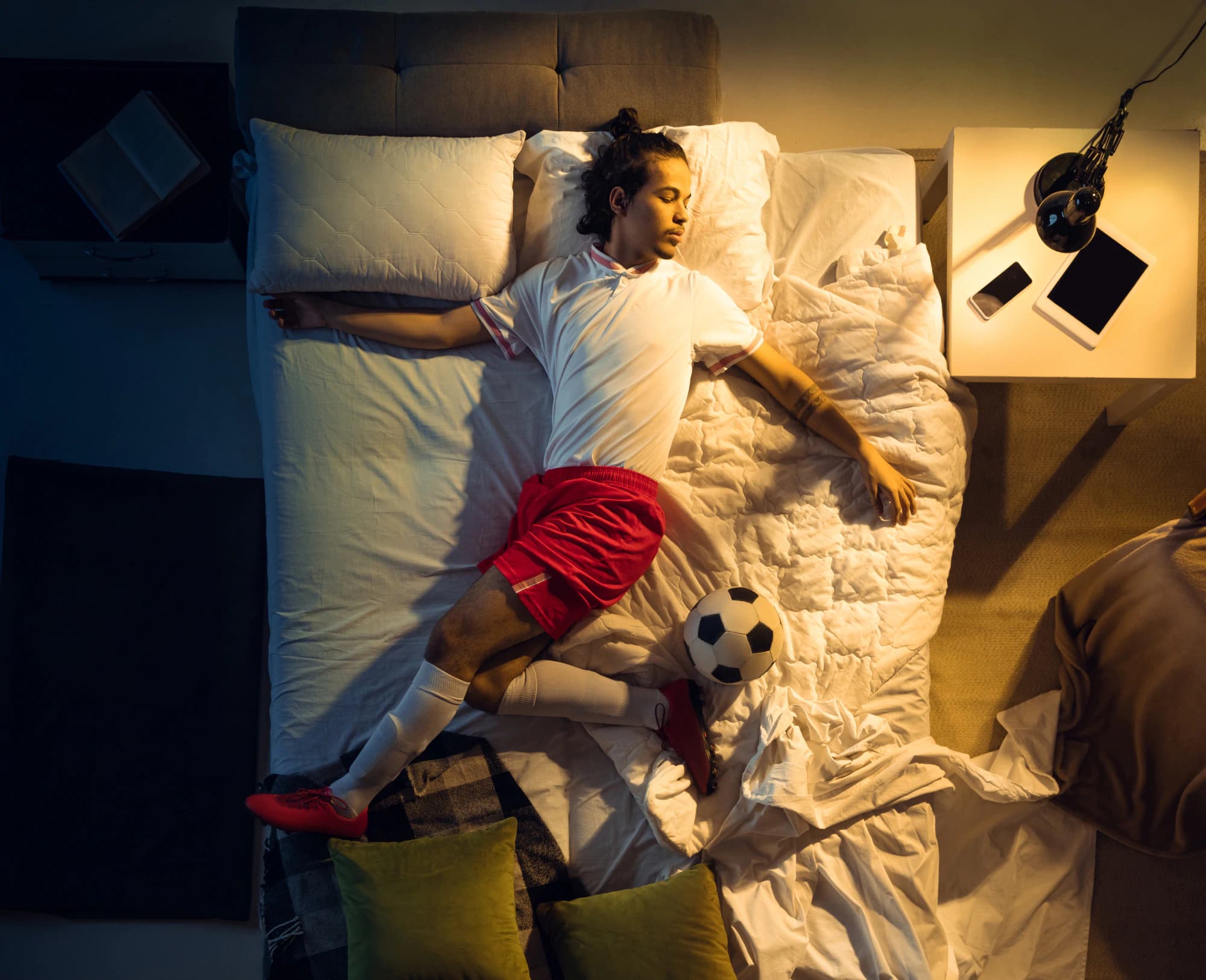 Soccer player posing with a soccer ball in his sleep