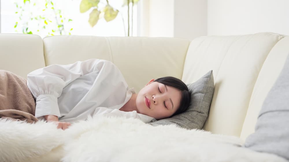 Woman taking a nap on her couch