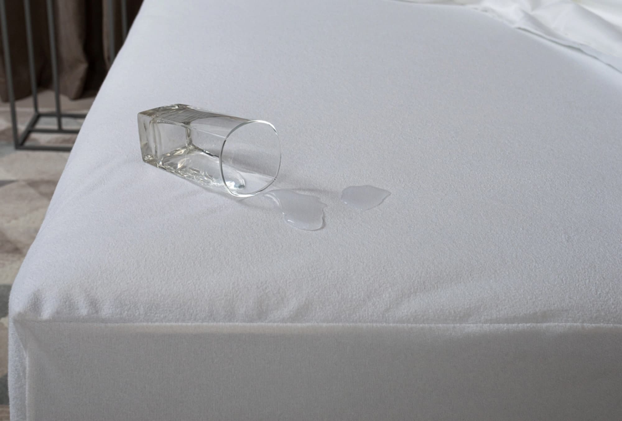 Mattress protector with water spilled on top