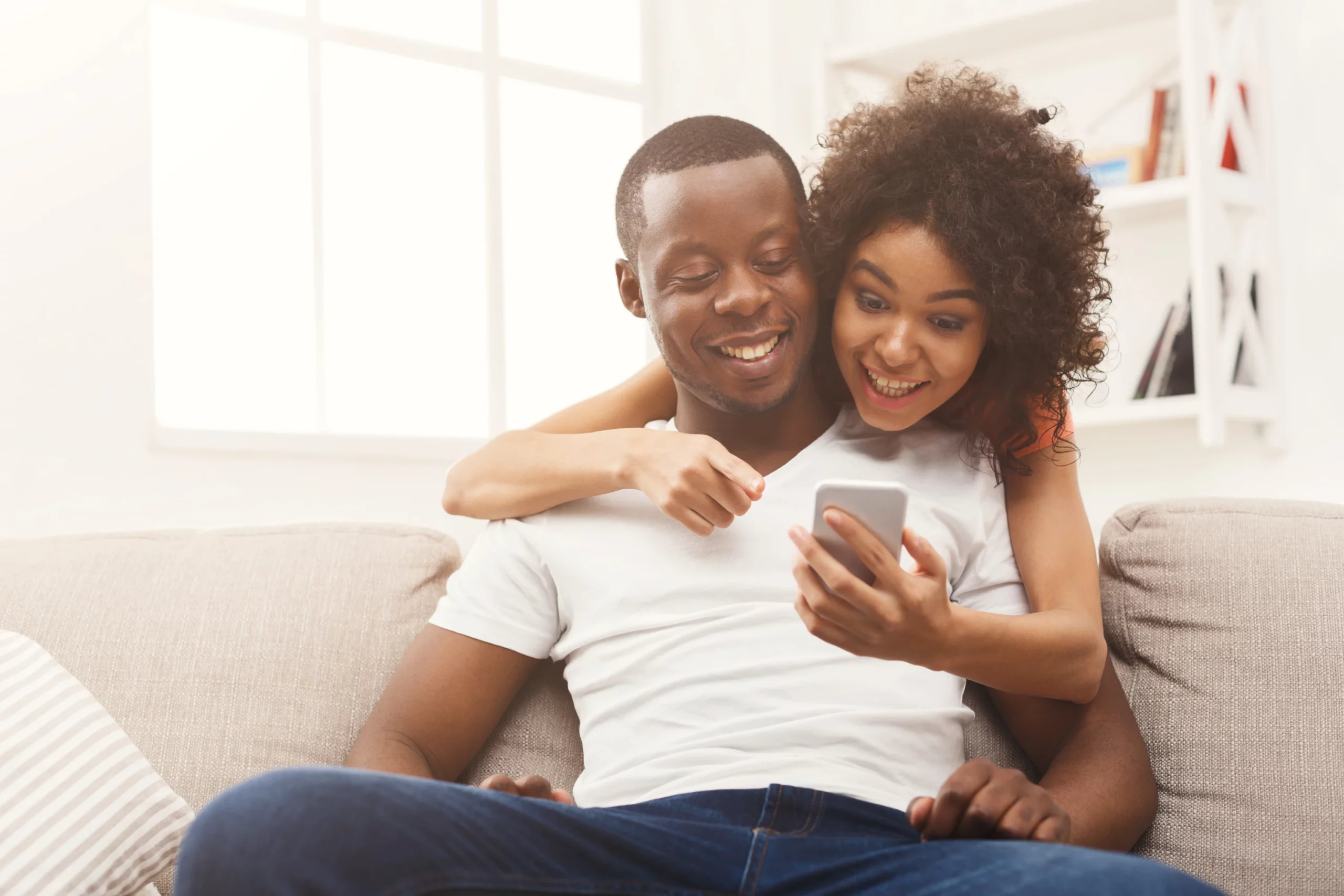 Happy couple using smartphone