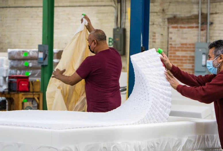 Two Texas Mattress Makers craftsmen making mattresses in our factory