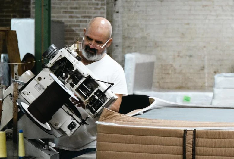 Texas Mattress Makers craftsman making a mattress in our factory