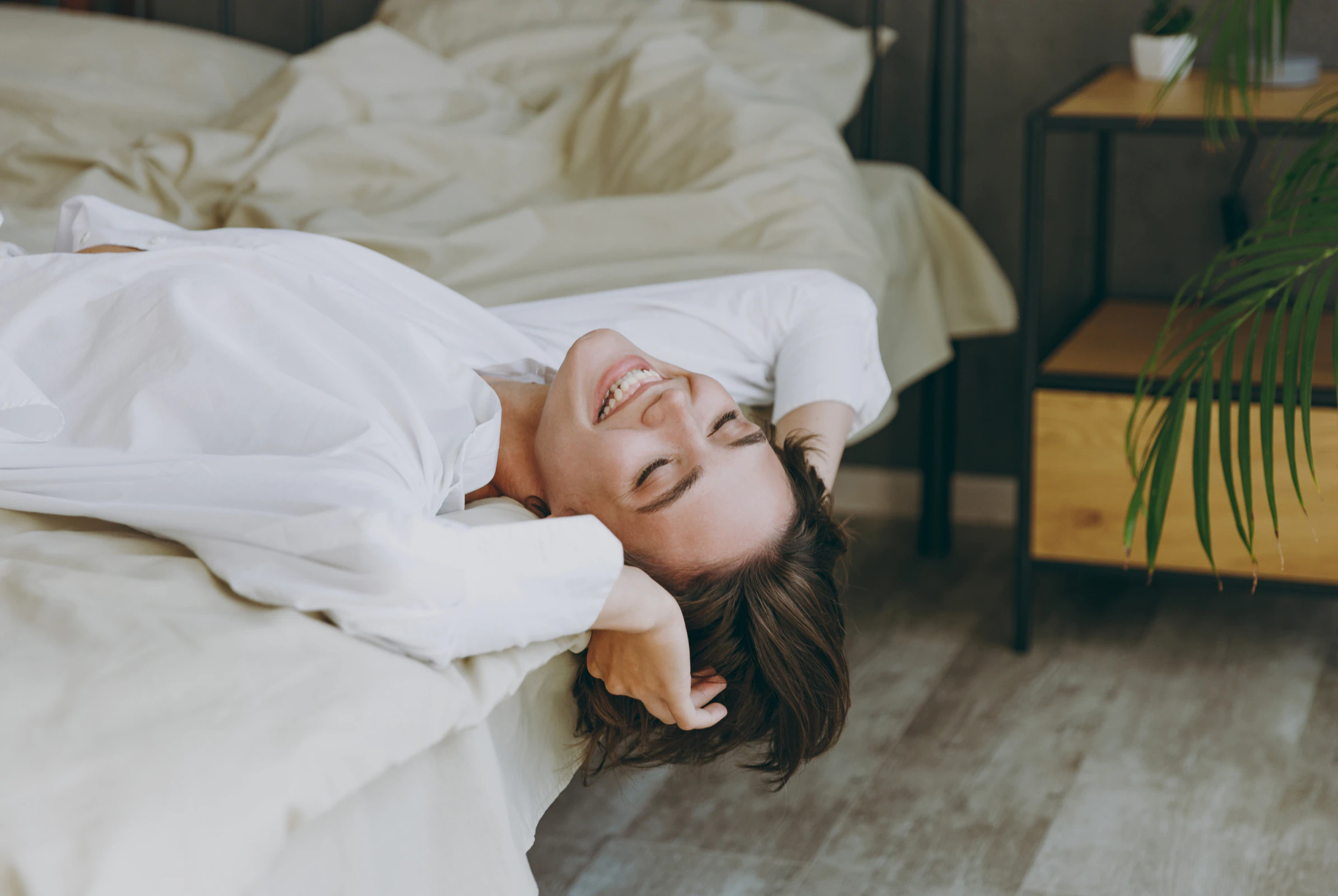 Side view calm fun young woman wear white shirt pajama she lying in bed