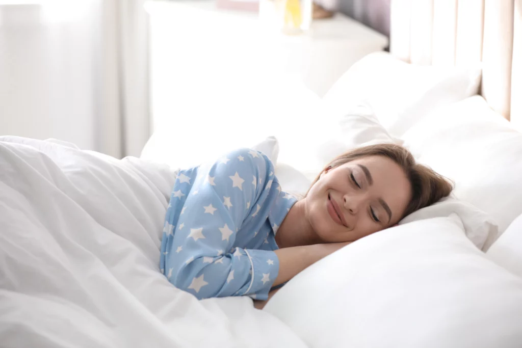 Woman in blue pajamas sleeping