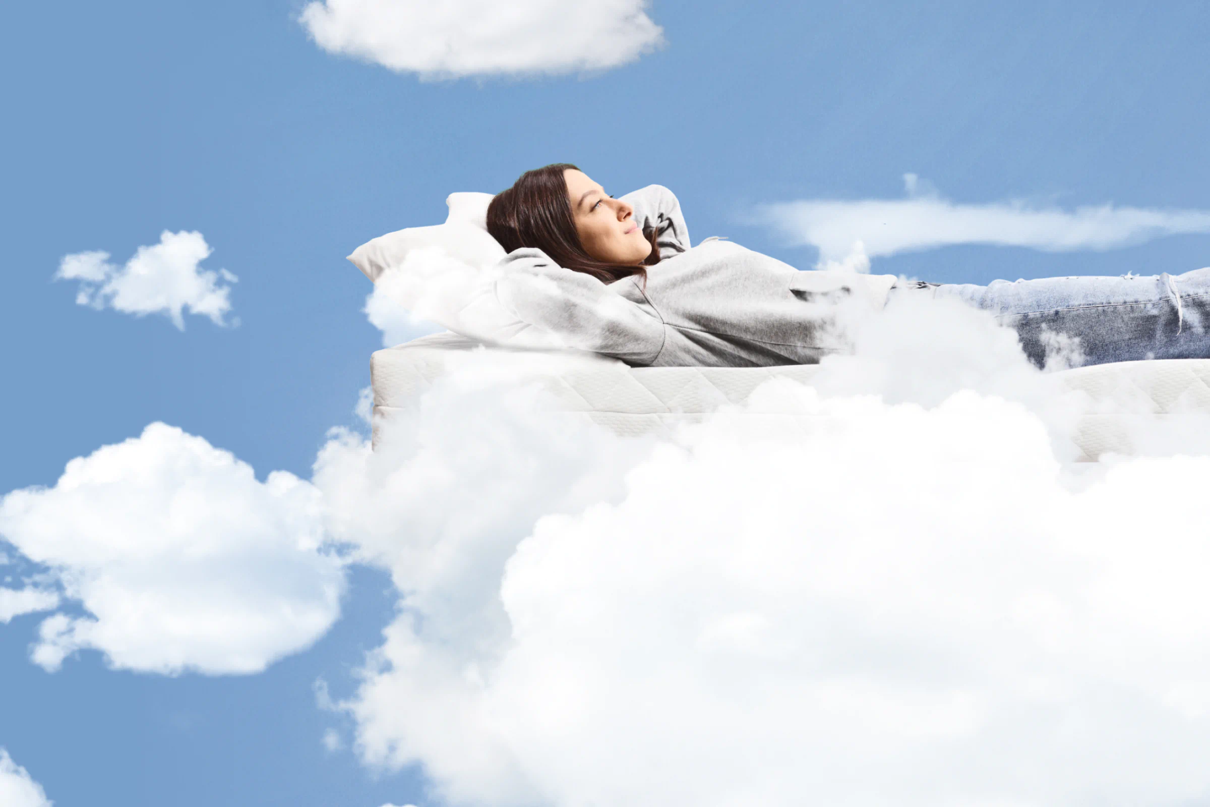 Woman sleeping on TMM mattress in the clouds